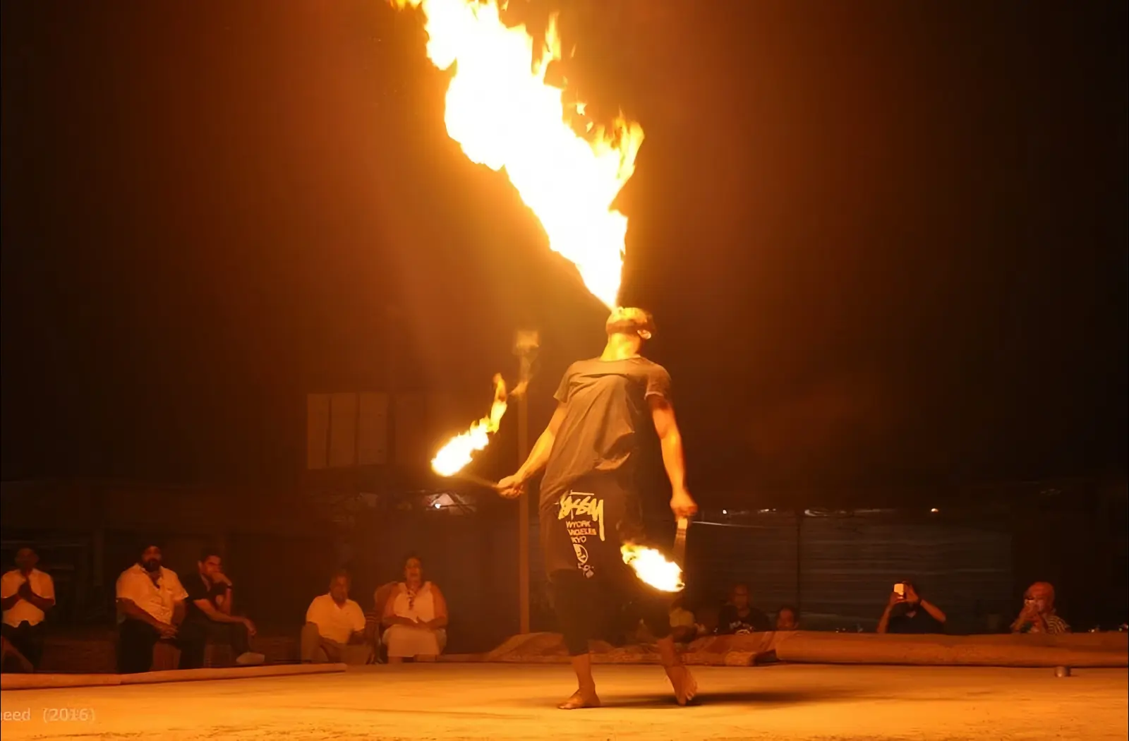 Guests enjoying a live fire performance during an evening desert safari in Dubai.