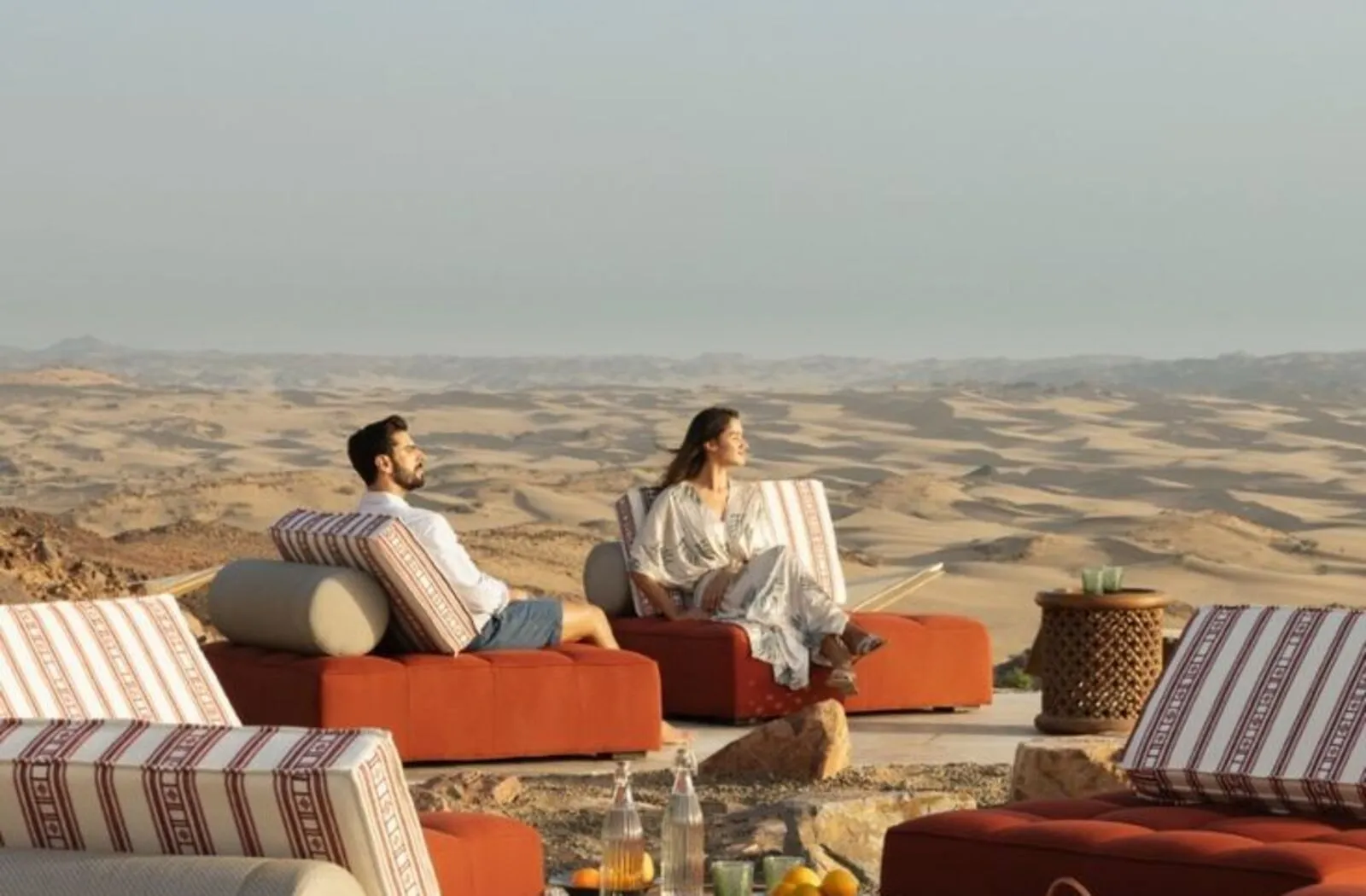 Couple enjoying a desert view from a luxury sitting area during a premium desert safari in Dubai.