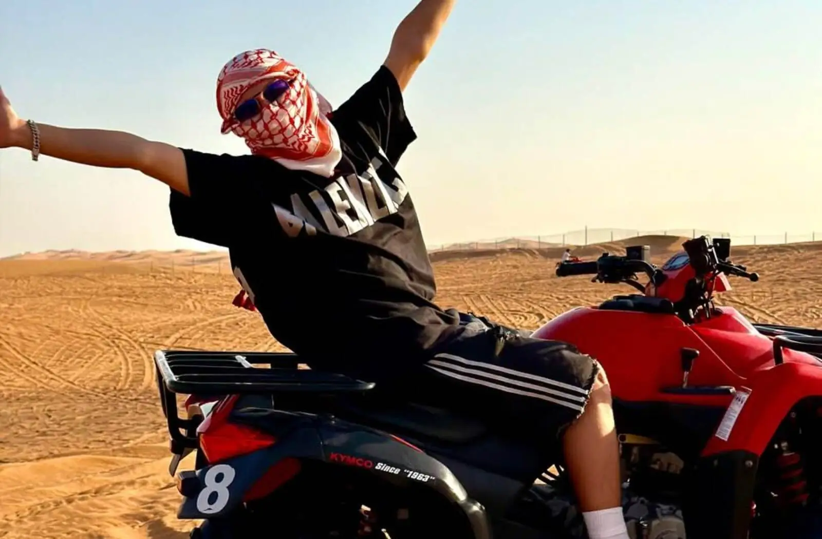 Guest posing on a quad bike during a desert safari in Dubai